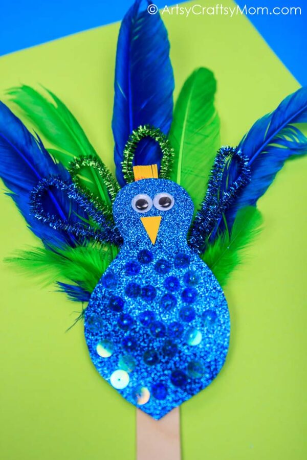 Easy Peacock craft for kids made using feathers, pipe cleaners & glitter paper. A fantastic craft to make after visiting the zoo & while learning about birds 