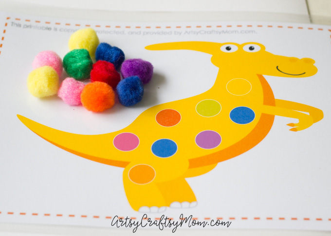 Kids love games; it's how they learn! Develop your child's color recognition & fine motor skills with a matching game using Printable Dinosaur Pom Pom Mats.