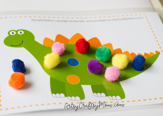 Kids love games; it's how they learn! Develop your child's color recognition & fine motor skills with a matching game using Printable Dinosaur Pom Pom Mats.
