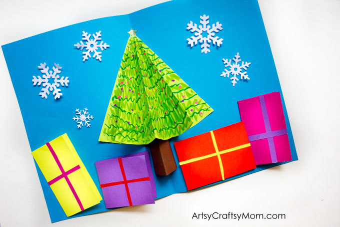 You can easily make your own 3D Christmas Tree Pop Up Card for family members and friends. Miniature presents hold your season's greetings at the bottom. 