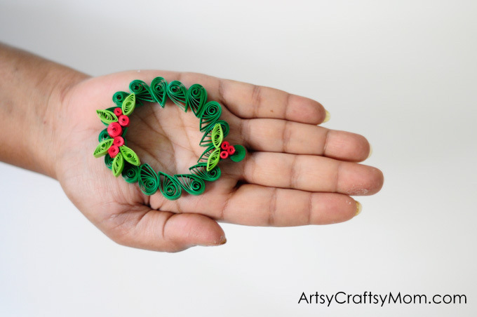 Wreaths are an integral part of Christmas decor! Make your own little version with this Paper Quilled Wreath - an easy Christmas ornament for your tree!