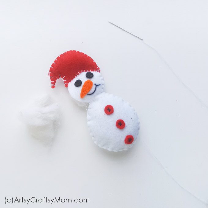 This Felt Snowman Christmas Ornament can brighten up any Christmas tree or mantle!! With our free printable template, this is perfect for sewing beginners!