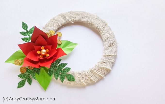 Make this Paper Poinsettia Wreath Craft to pretty up your front door this holiday season - with a little bit of rustic flavor and a little bit of glitter! 