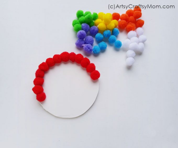 Create your very own magical rainbow with this easy pom pom rainbow craft! This is a great project for little kids to learn about colors and more!