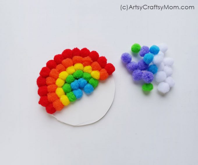 Create your very own magical rainbow with this easy pom pom rainbow craft! This is a great project for little kids to learn about colors and more!