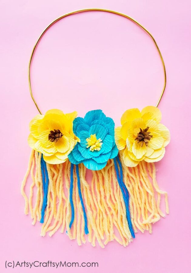 Let your walls bloom with this DIY Yarn Floral Wall Hanging! Easy to make and the perfect way to bring spring and nature indoors!