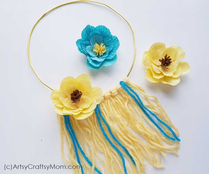 Let your walls bloom with this DIY Yarn Floral Wall Hanging! Easy to make and the perfect way to bring spring and nature indoors!
