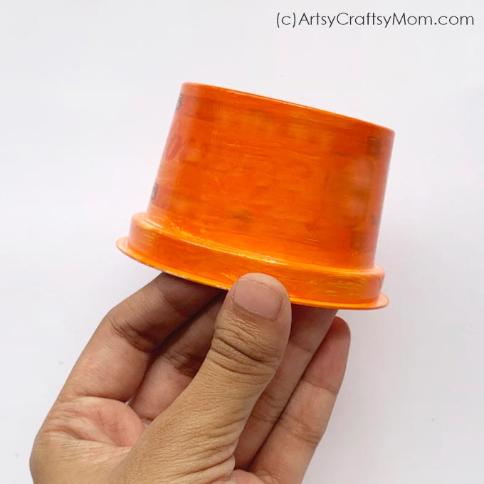 This recycled plastic cup pumpkin craft is super cute and so easy to make! All you need is a plastic cup, paint, paper and you're all set!