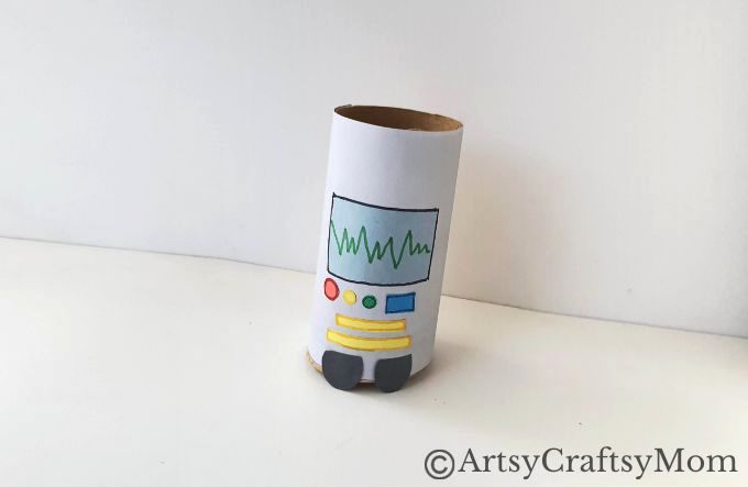 Attach the eyes and the mouth cutout on the head pattern of the robot figure.