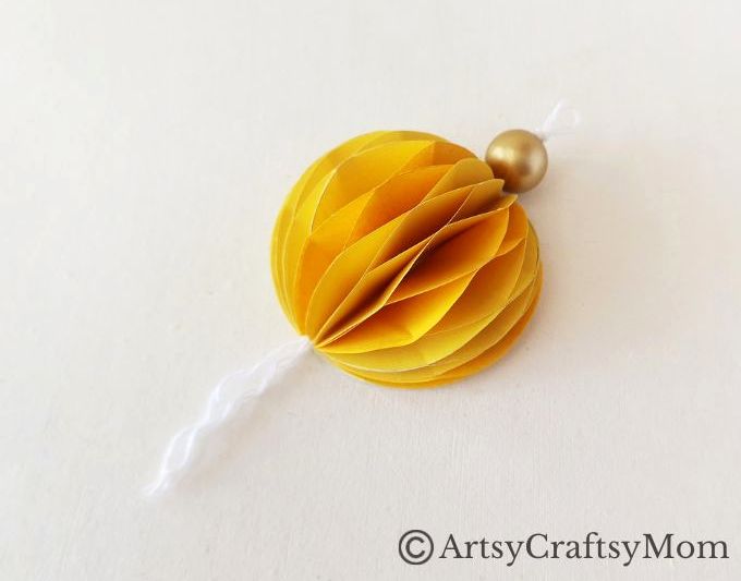 Try something different this holiday season - make a pretty 3D Christmas Ornament for your tree, entirely out of colored craft paper!